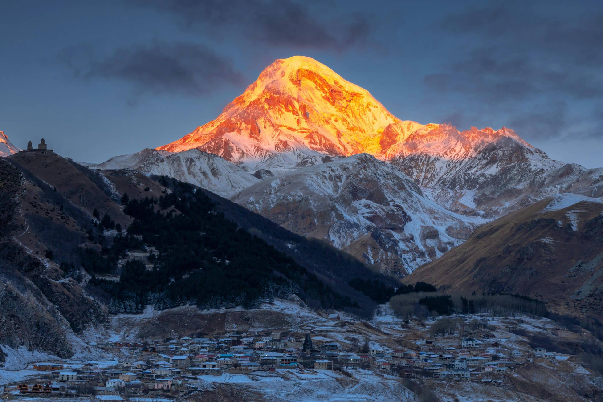 Sunlight reflecting from snow capped mountain in Georgia